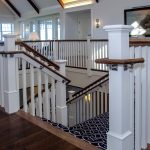 Commercial stair with box newels, wood balusters, and and ADA compliant handrail.