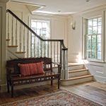 Straight L-shaped stair with wood balusters and turned newel post.
