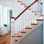 Straight scissor stair with box newels and wood balusters. Stair features reclaimed wood treads and sepele mahogany railing. Stair has a slight flair at its base.