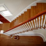 Curved stair with box newels and wood balusters.