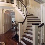 Curved stair with wood balusters and custom box newels.