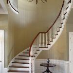 Curved stair with wood balusters.