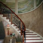 Curved stair with custom wrought iron balusters.