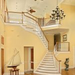 Flared stair with wood balusters and over-the-post railing.