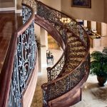 Unsupported curved stair with custom wrought iron balusters.