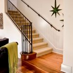 Straight stair with wrought iron balusters.