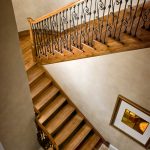 Straight scissor stair with wrought iron balusters.