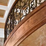Curved stair with custom wrought iron balusters.