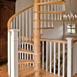 Spiral staircase with wood balusters and box newels.