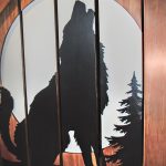 Custom carved balustrade with the image of a wolf.