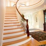 Flared stair with a custom legacy newel post an wood balusters.