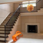Modern styled straight stair with wrought iron balusters.