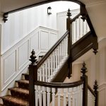 Straight stair with wood balusters and custom newels in a historic home.