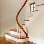 Winding staircase with a unique custom curved rail.