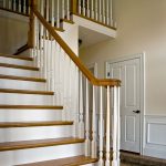 Over-the-post L-shaped stair with wood balusters.
