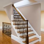 Stair with wrought iron balusters and turned wood newels post.