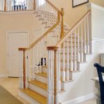 L-shaped over-the-post stair with wood balusters.