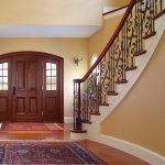 Curved stair with wrought iron balusters.