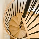 Spiral staircase with black balusters.