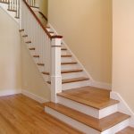 Straight stair with box newels and wood balusters. Stair features a cascading starting step.