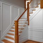 Straight L-shaped stair with box newels and wood balusters.