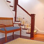 L-shaped straight stair with box newels and custom wood balusters.