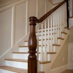 Stair with a custom legacy newel post and wood balusters.