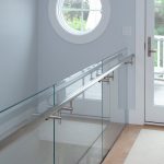 Stair with glass railing in a modern home.